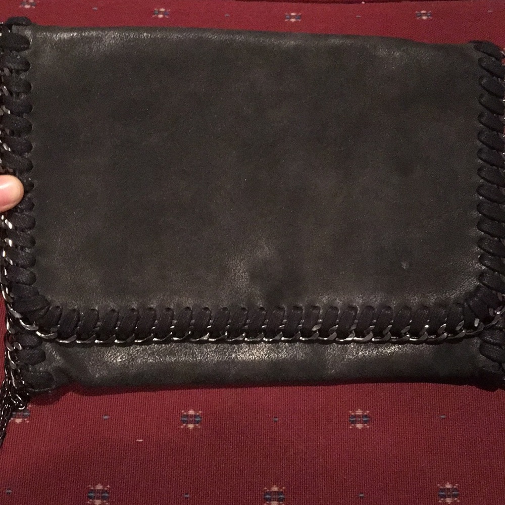 Black clutch purse with chain strap and detailing